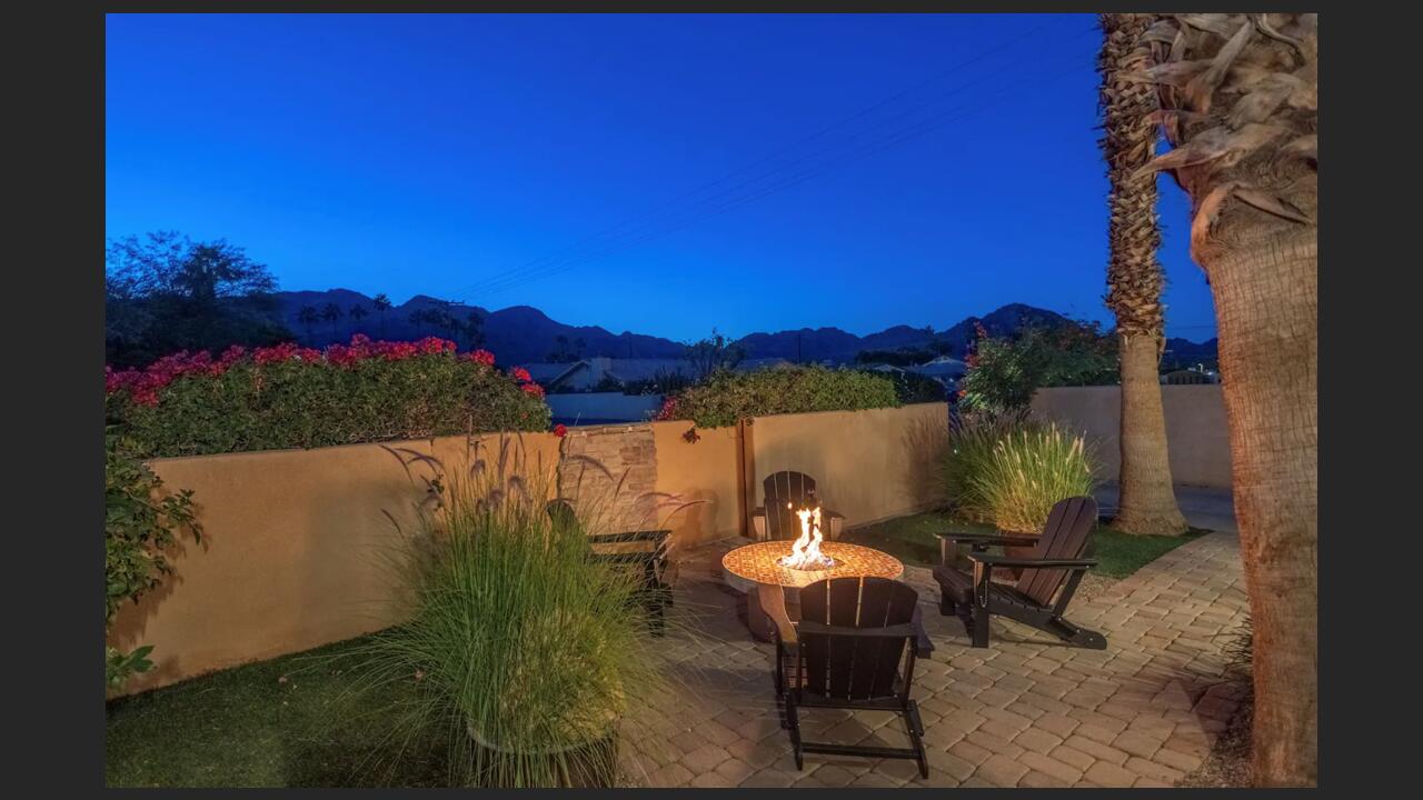 a view of a chairs and table in patio