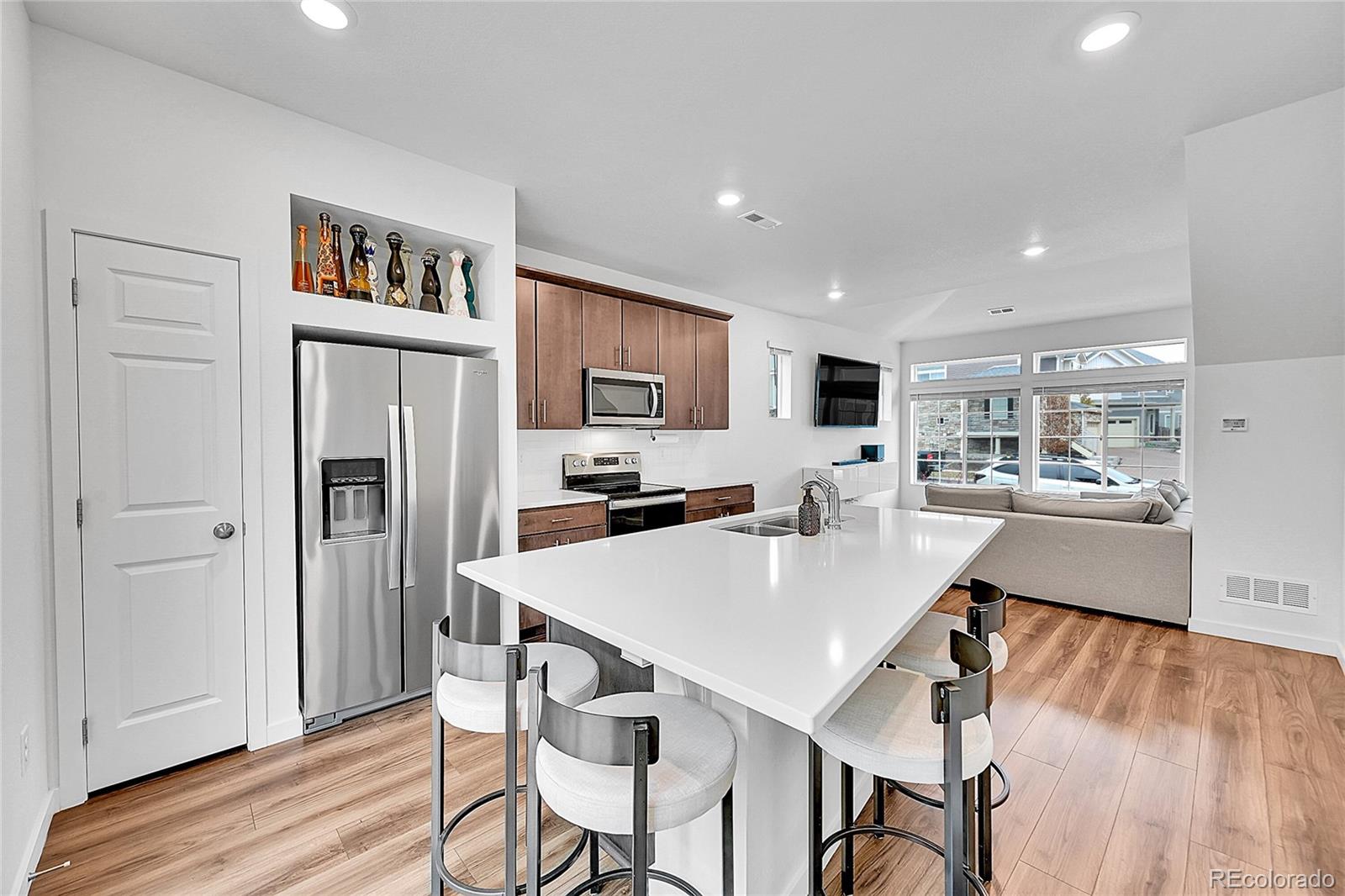 a large kitchen with a table and chairs