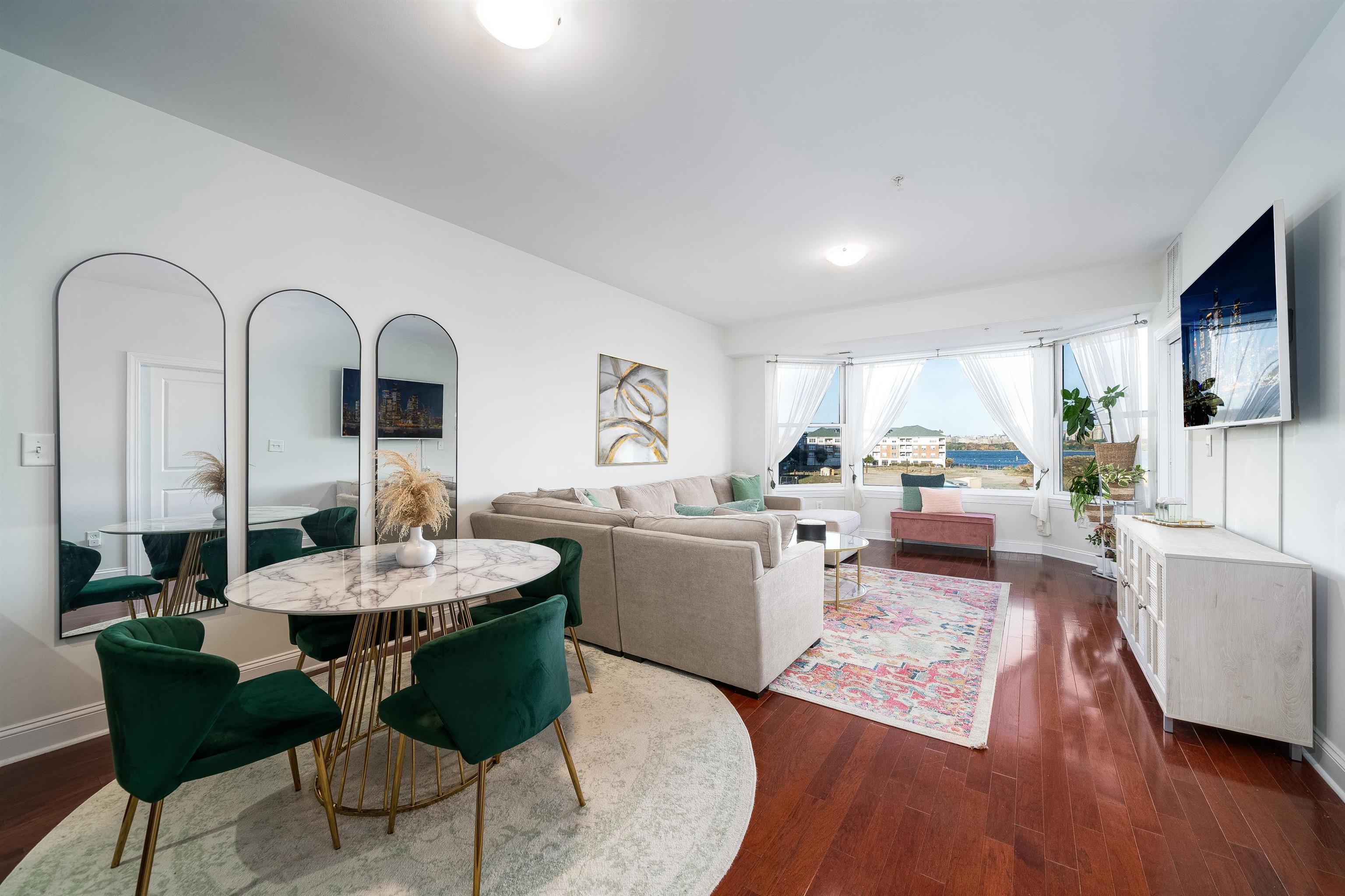 a living room with furniture and a wooden floor