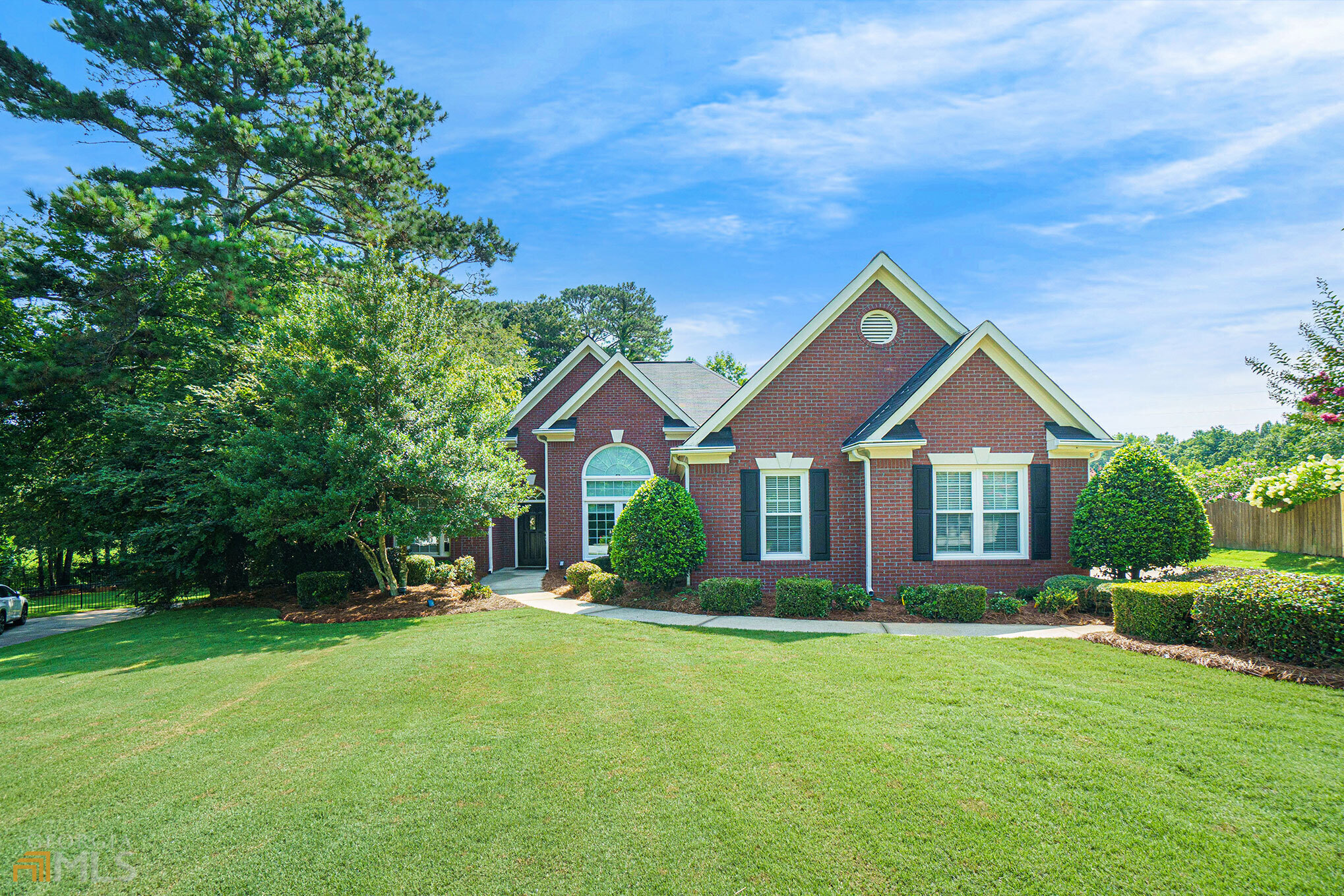 a front view of house with yard and green space