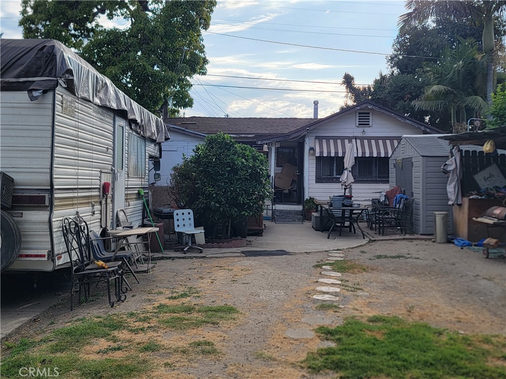 a view of backyard with outdoor seating and plants