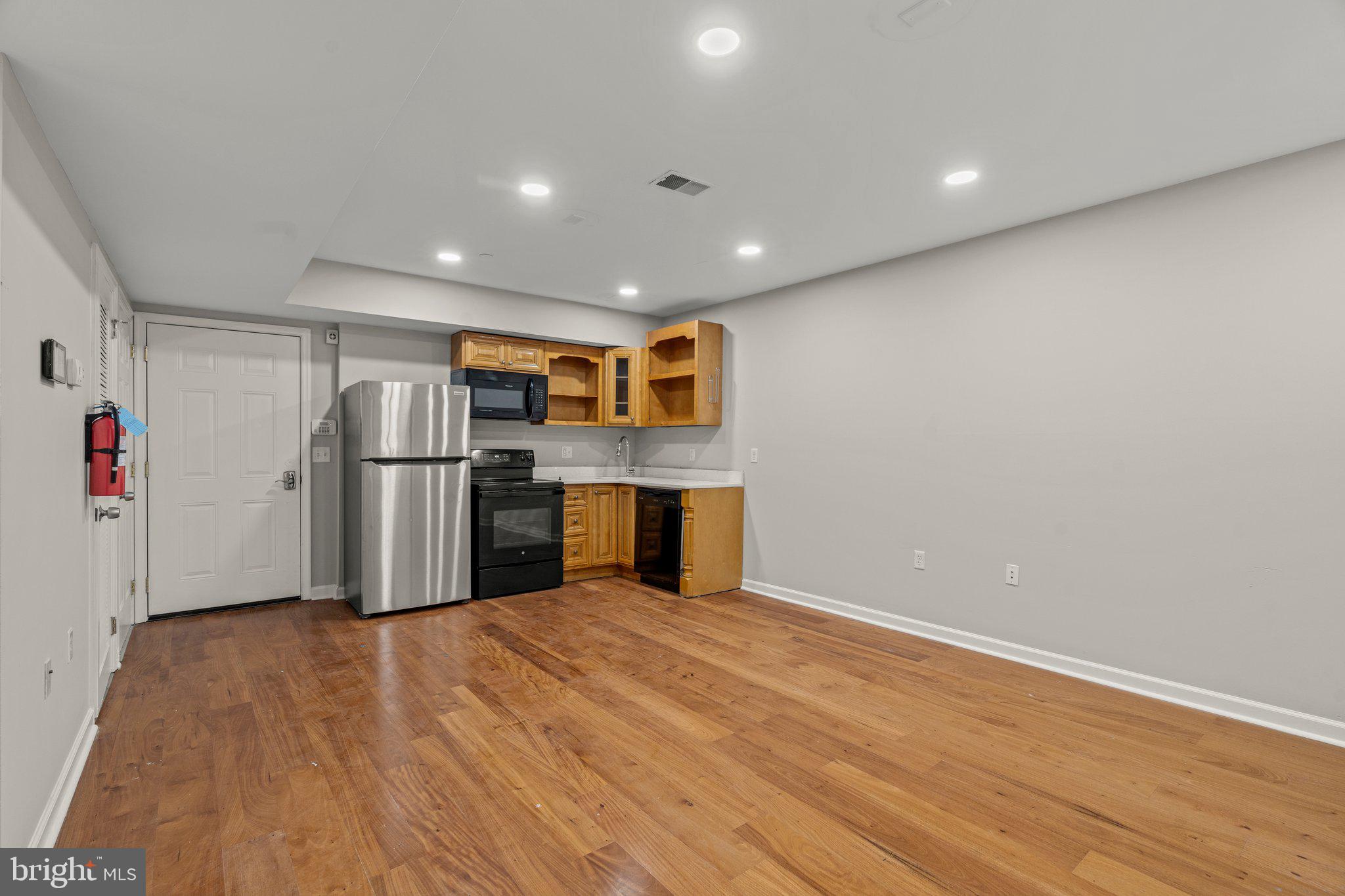 a kitchen with stainless steel appliances a refrigerator and a stove top oven