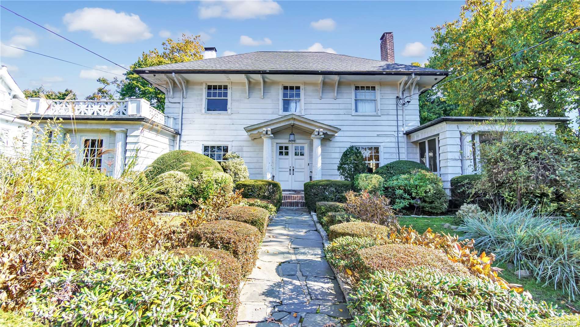 a front view of a house with garden