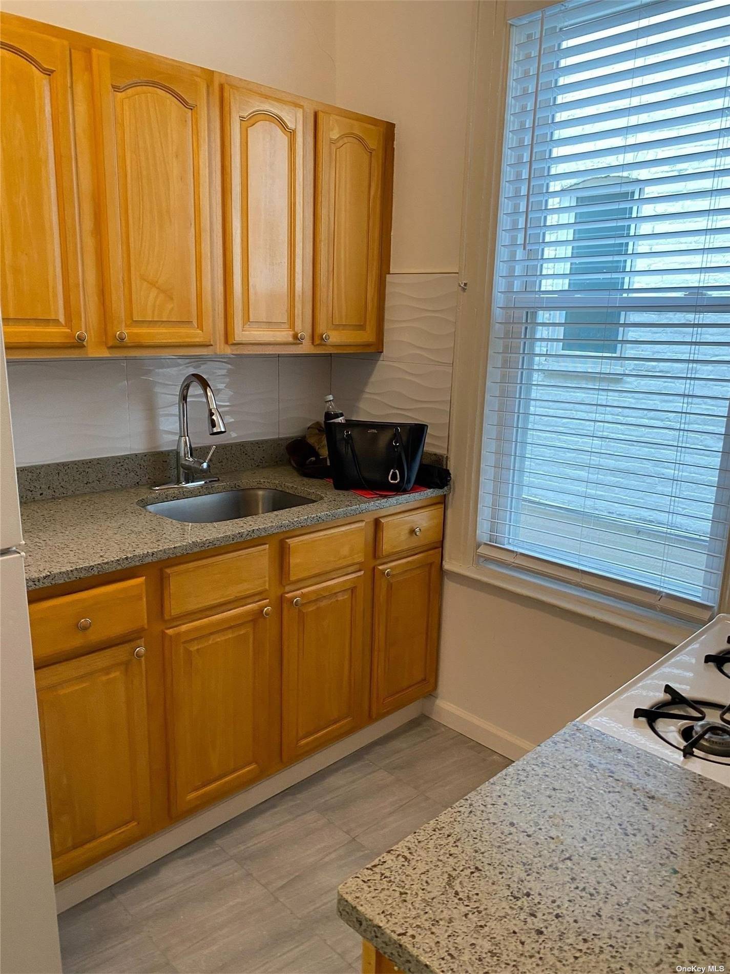 a kitchen with stainless steel appliances granite countertop a sink stove and cabinets