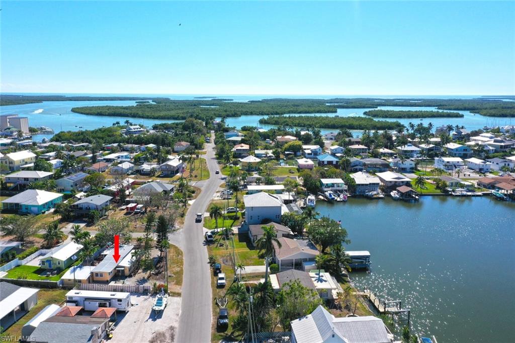 an aerial view of a city with lots of residential buildings and lake view