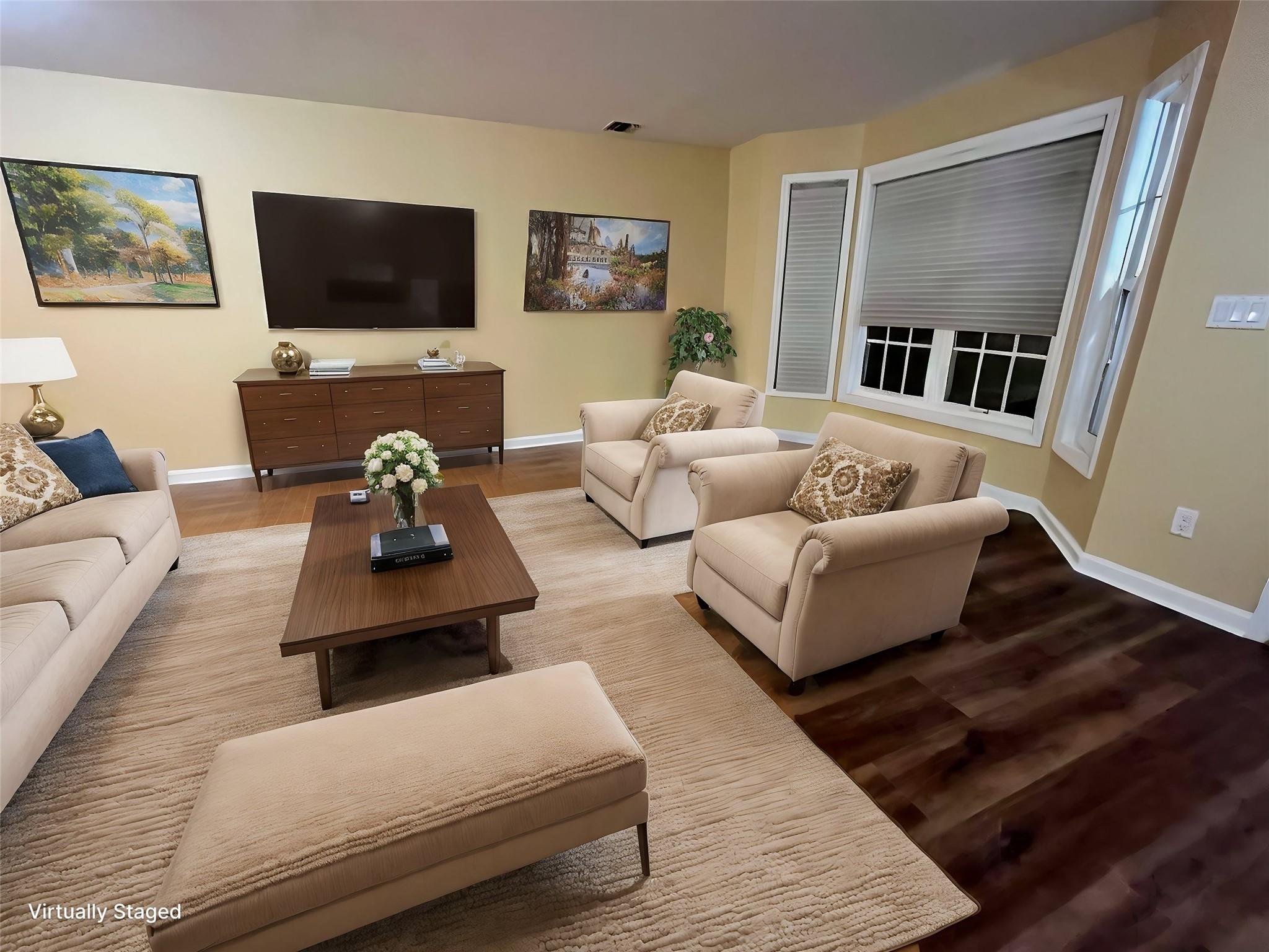 a living room with furniture and a flat screen tv