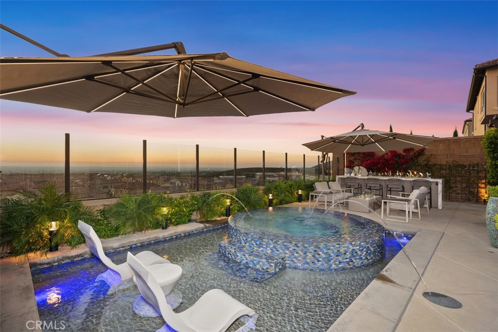 a patio with a table and chairs under an umbrella