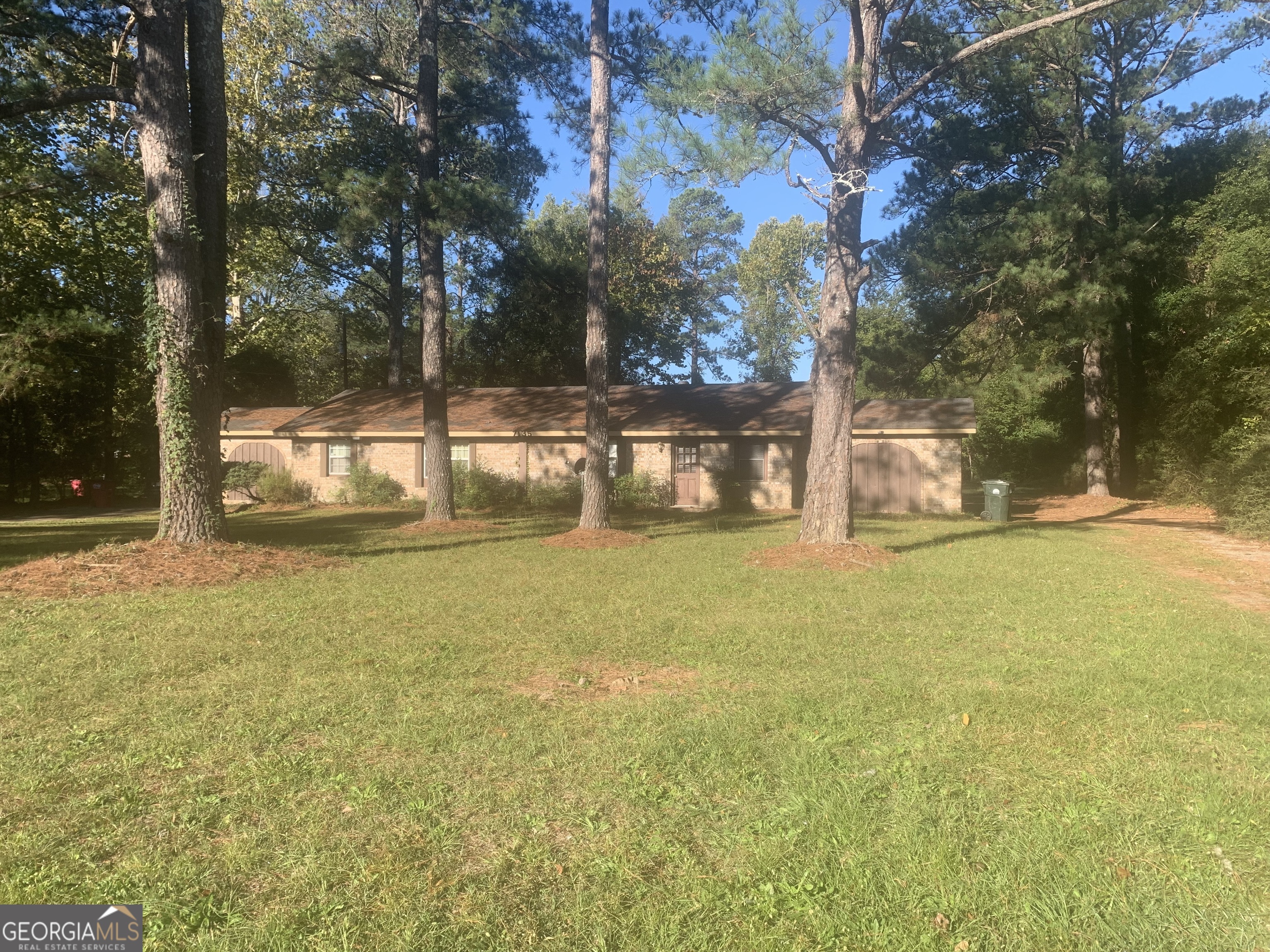 a view of a yard with swimming pool