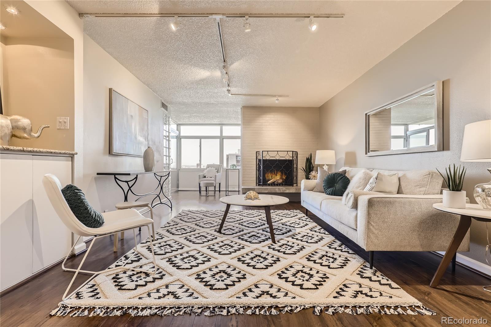 a living room with furniture and a fireplace