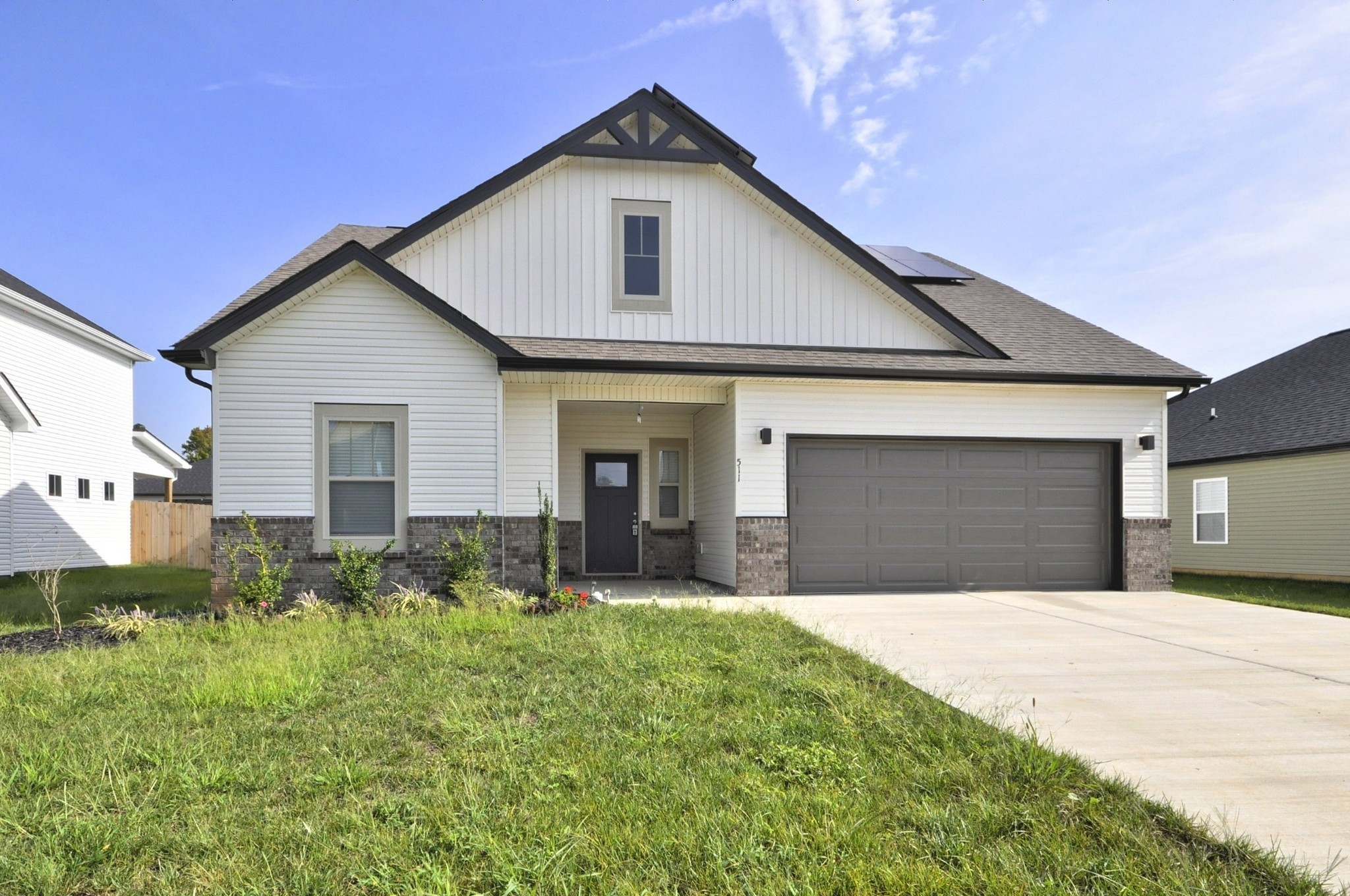 a front view of a house with a yard and garage