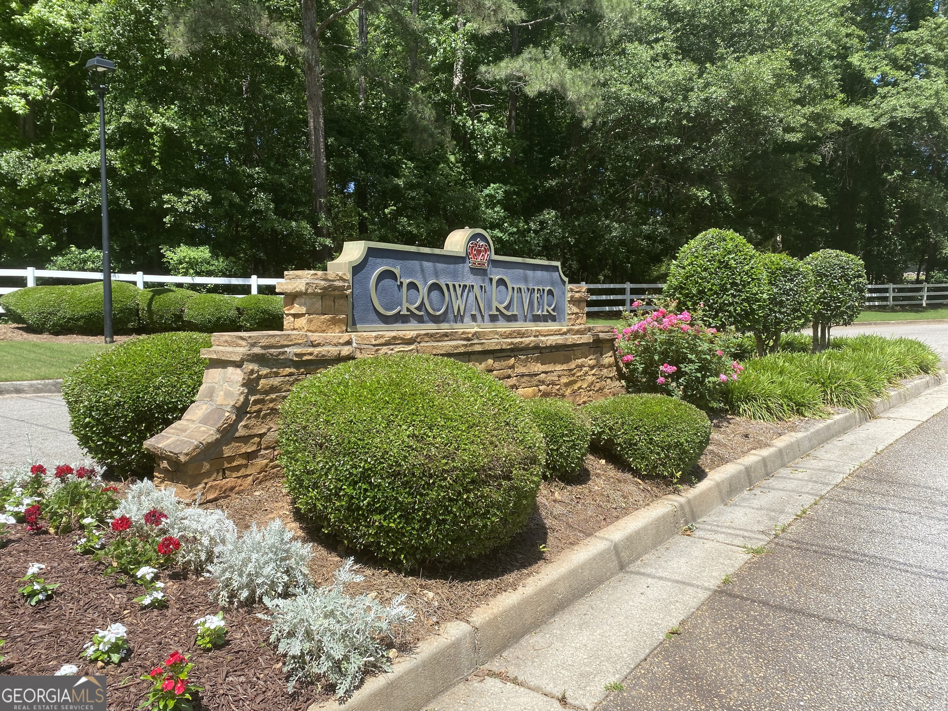 a front view of a house with a yard and fountain