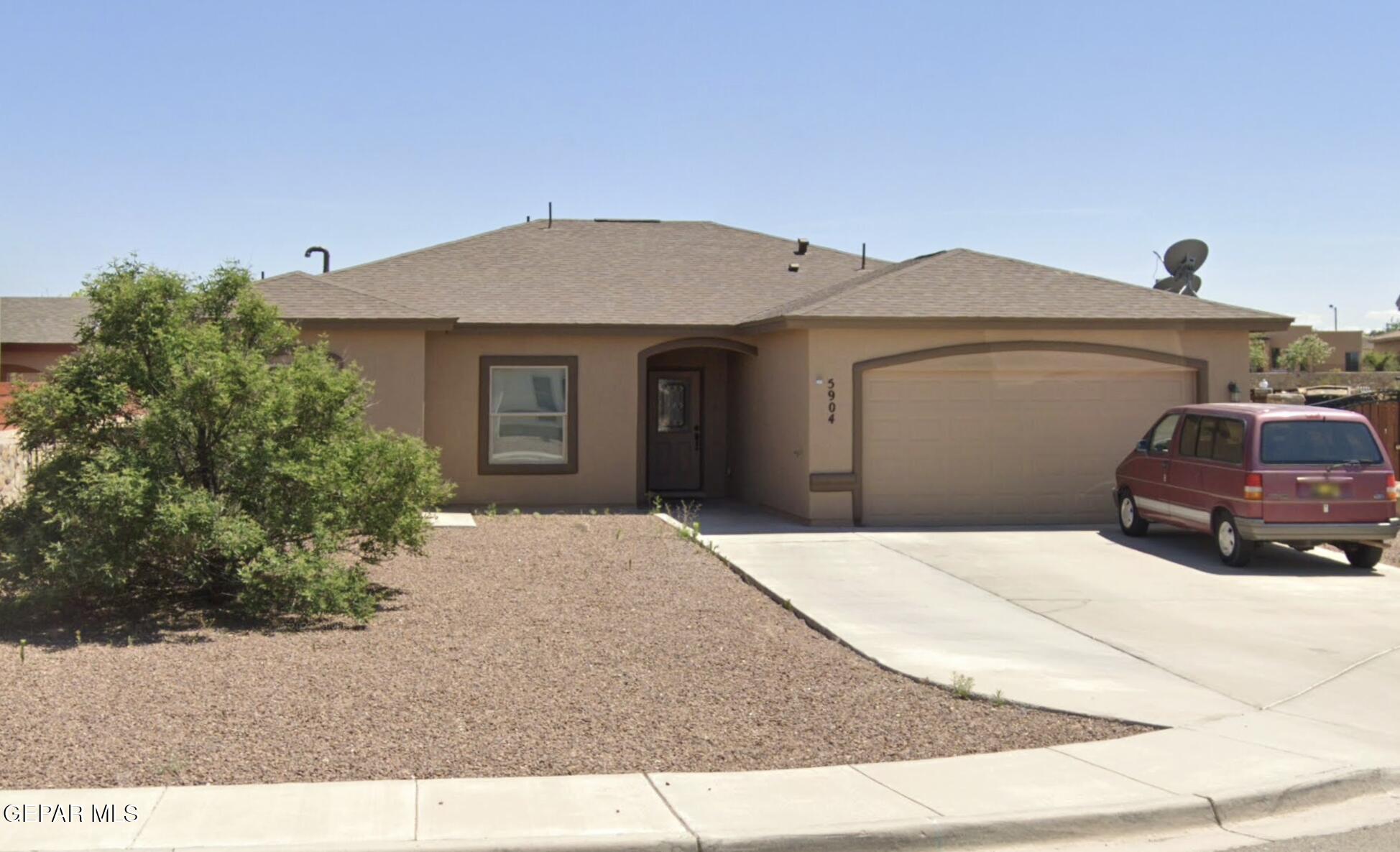 a front view of a house with garage