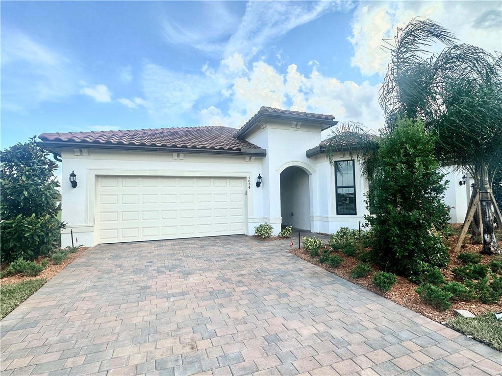 a view of a house with a yard and garage