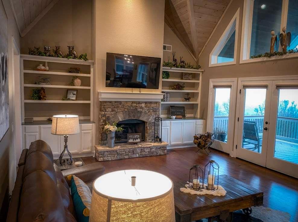 a living room with furniture a flat screen tv and a fireplace