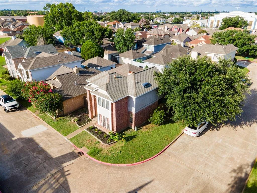 an aerial view of a house with a garden and trees