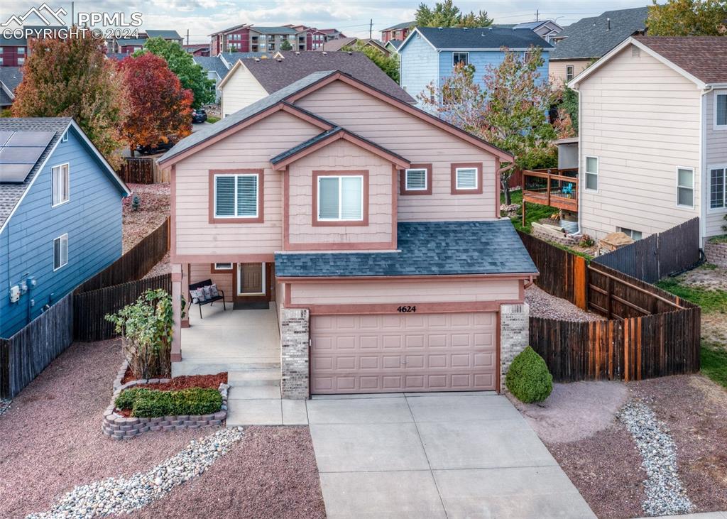 a aerial view of a house with a yard and potted plants