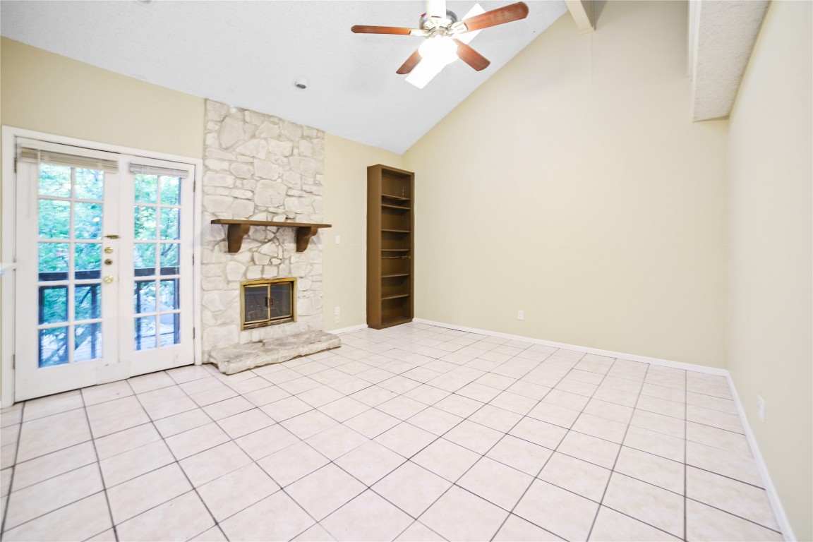 a view of an empty room with a fireplace