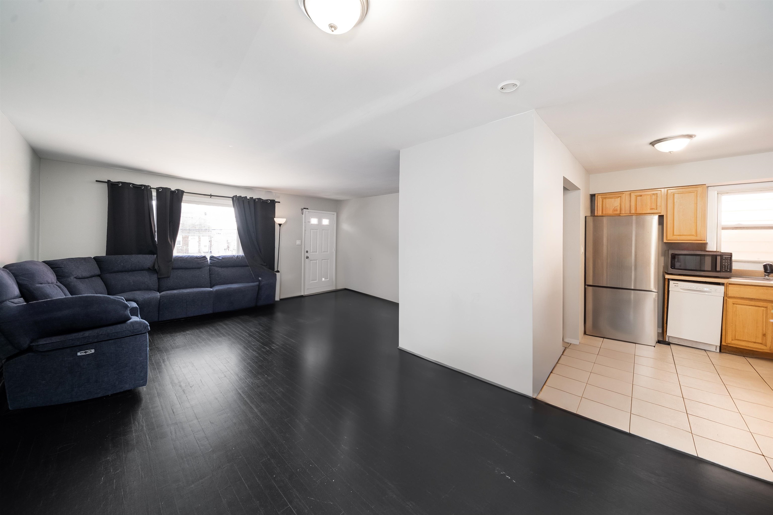 a living room with furniture and a kitchen