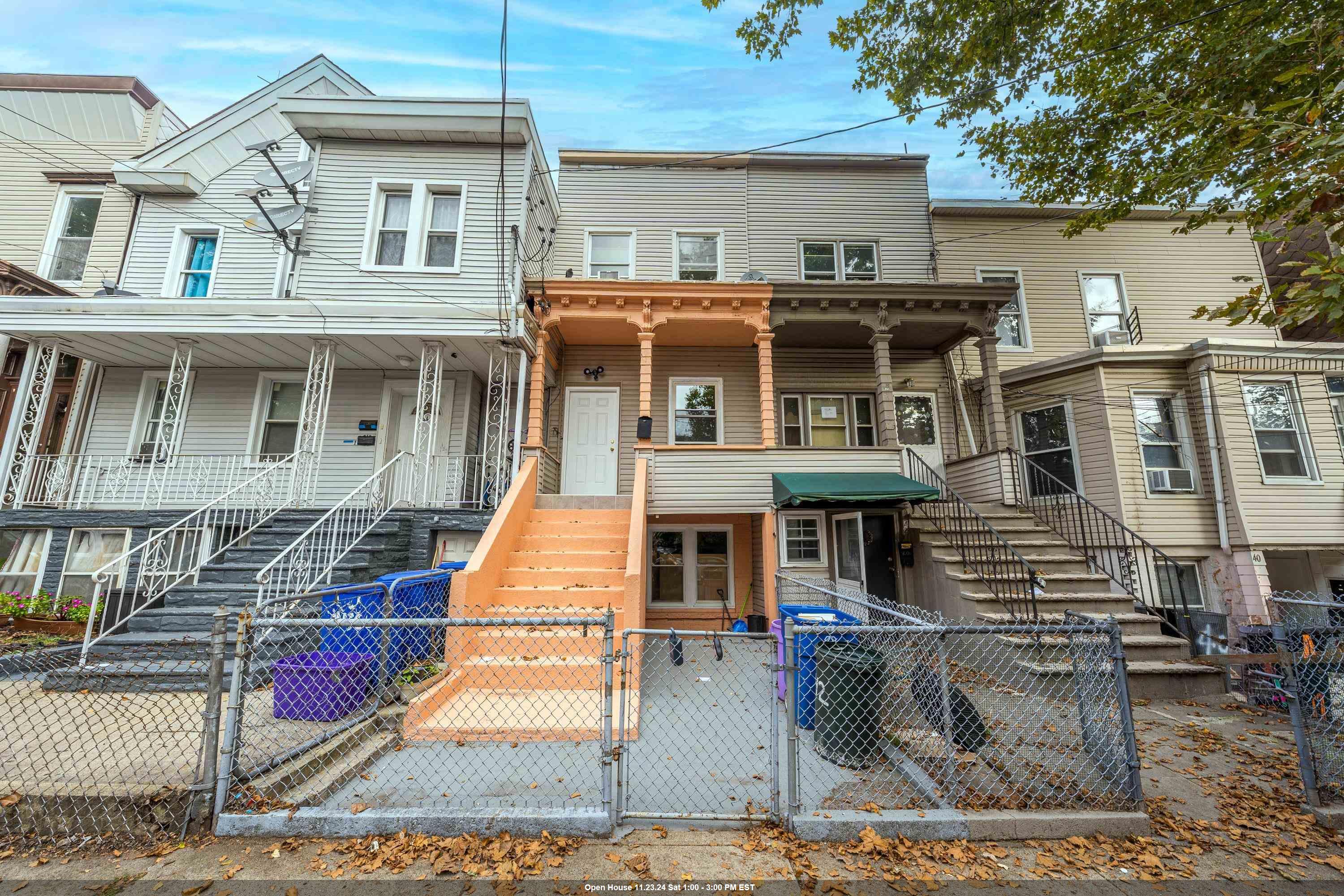 a front view of a residential apartment building with a yard