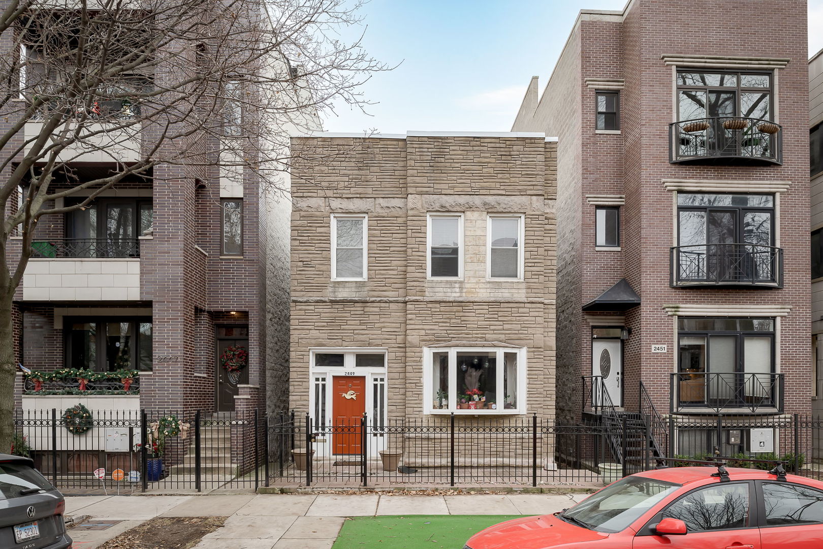 a front view of a residential apartment building with a yard