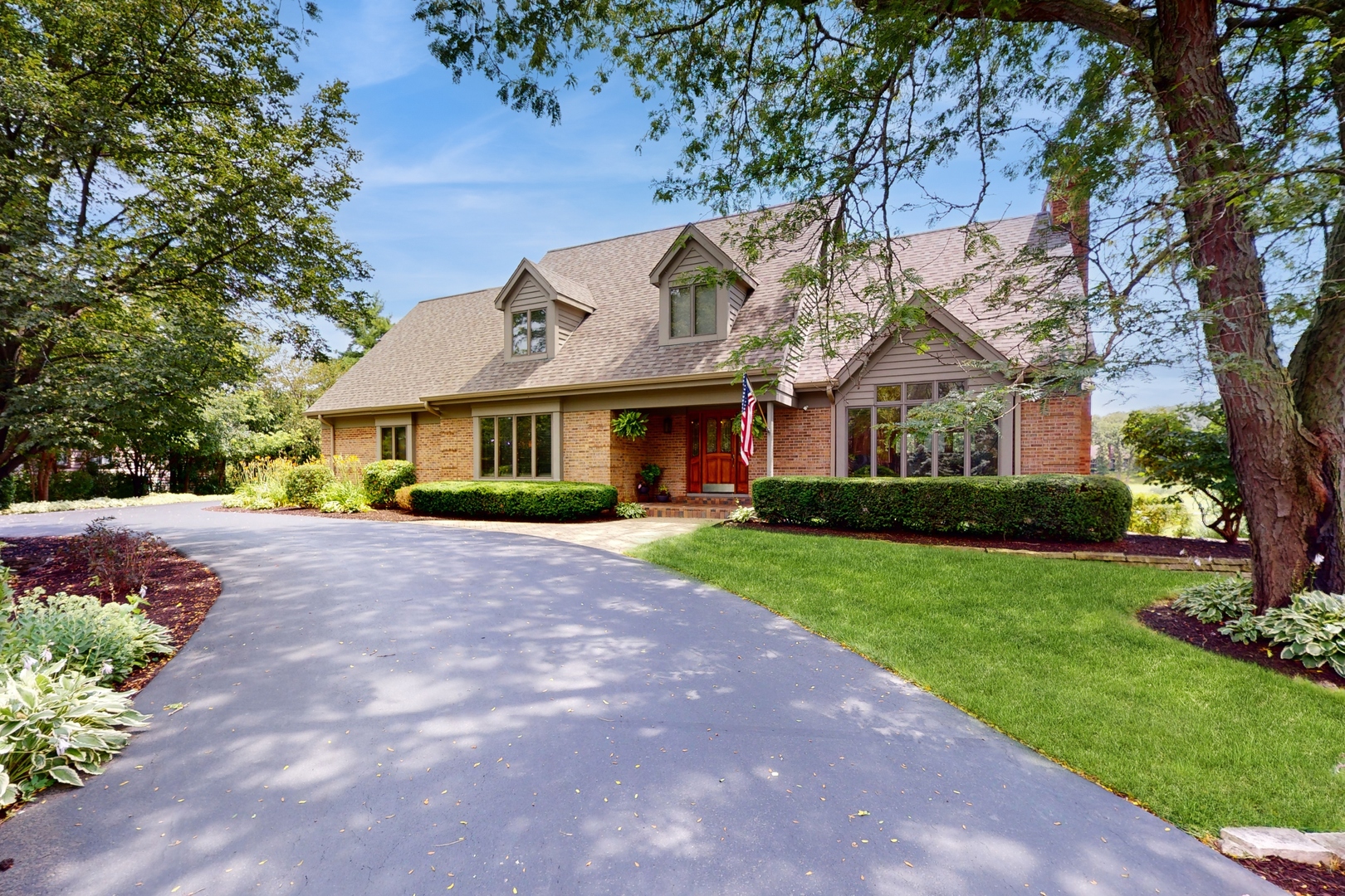 a front view of a house with a garden