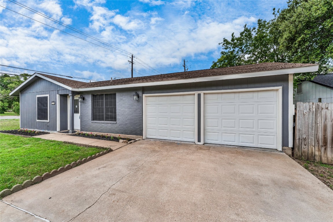 a view of a house with garage and yard