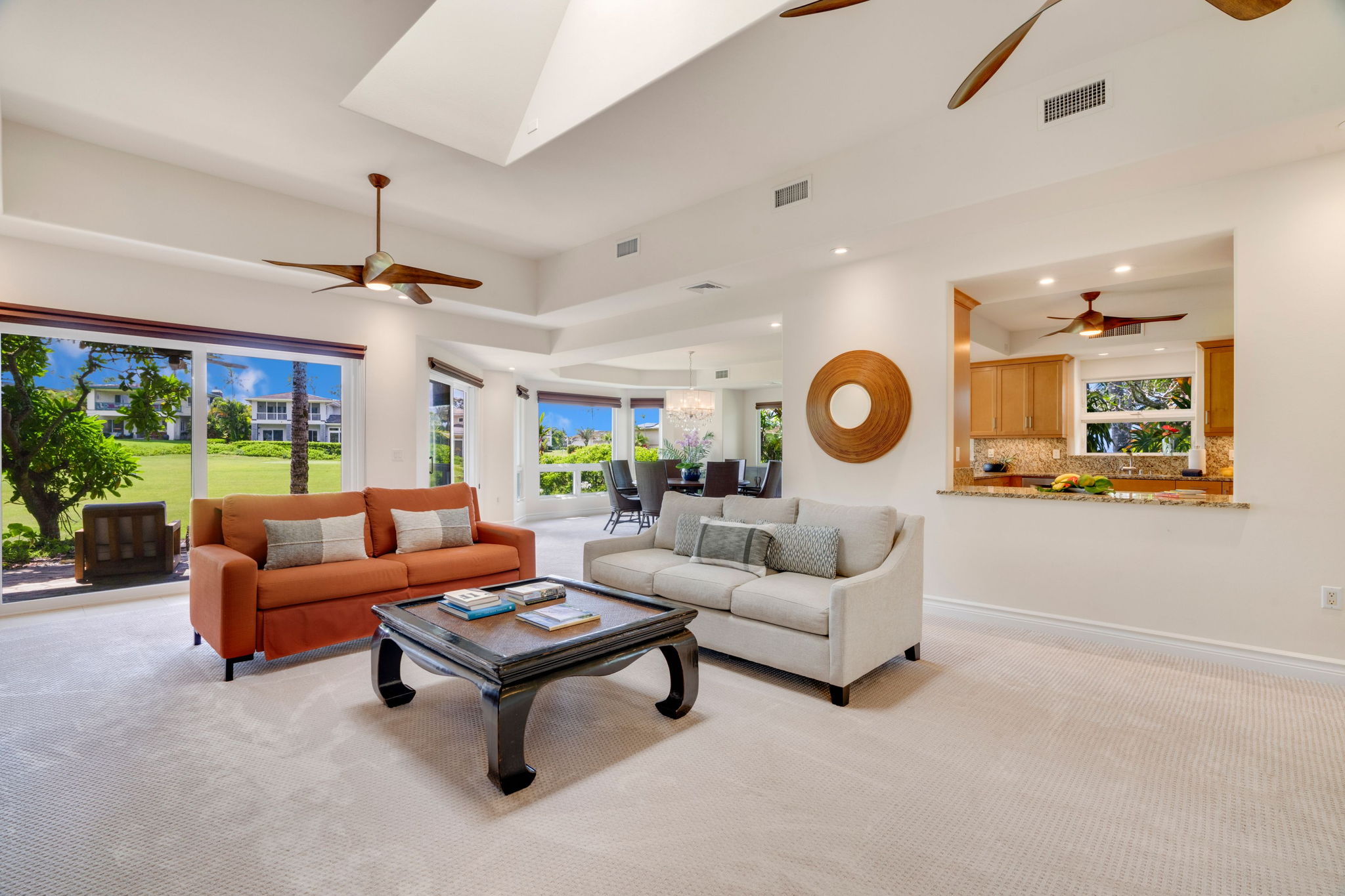 a living room with furniture a chandelier and a large window