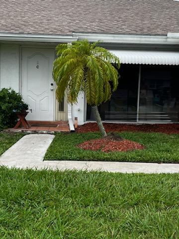 a front view of a house with a garden