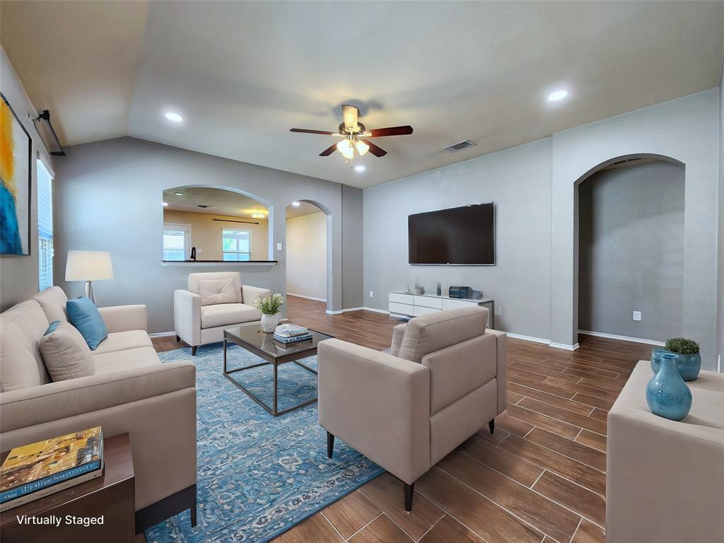 a living room with furniture and a flat screen tv