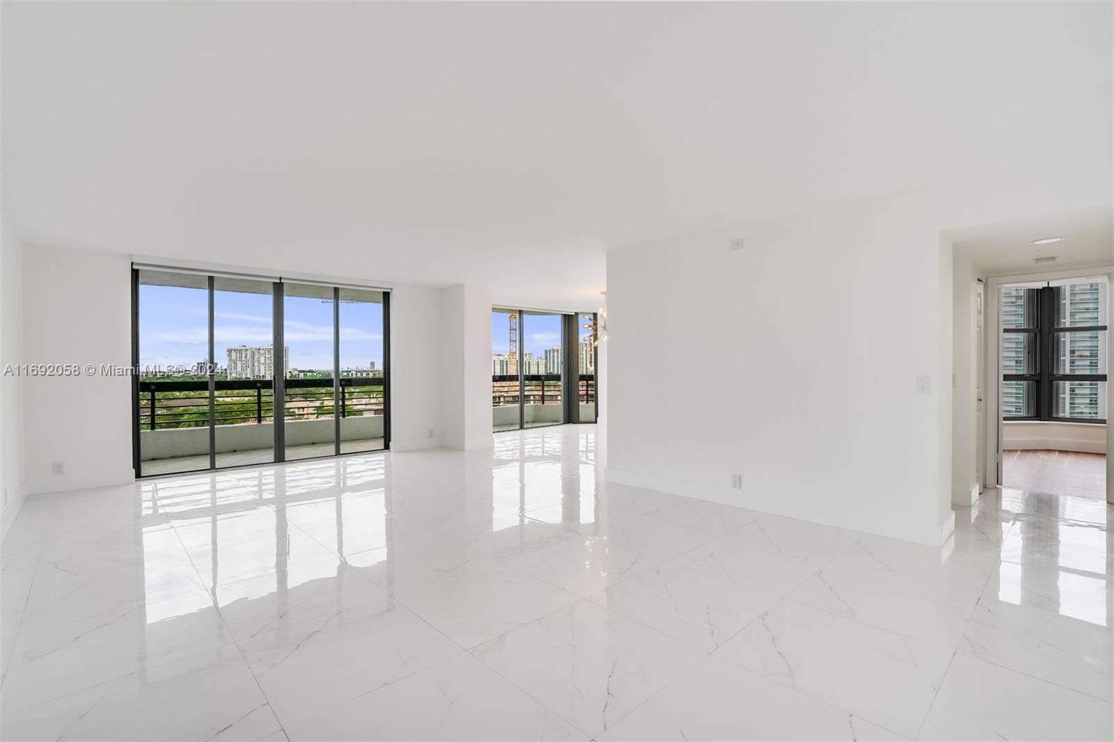 an empty room with sliding door and balcony