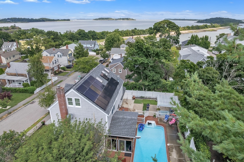 an aerial view of multiple houses with a yard