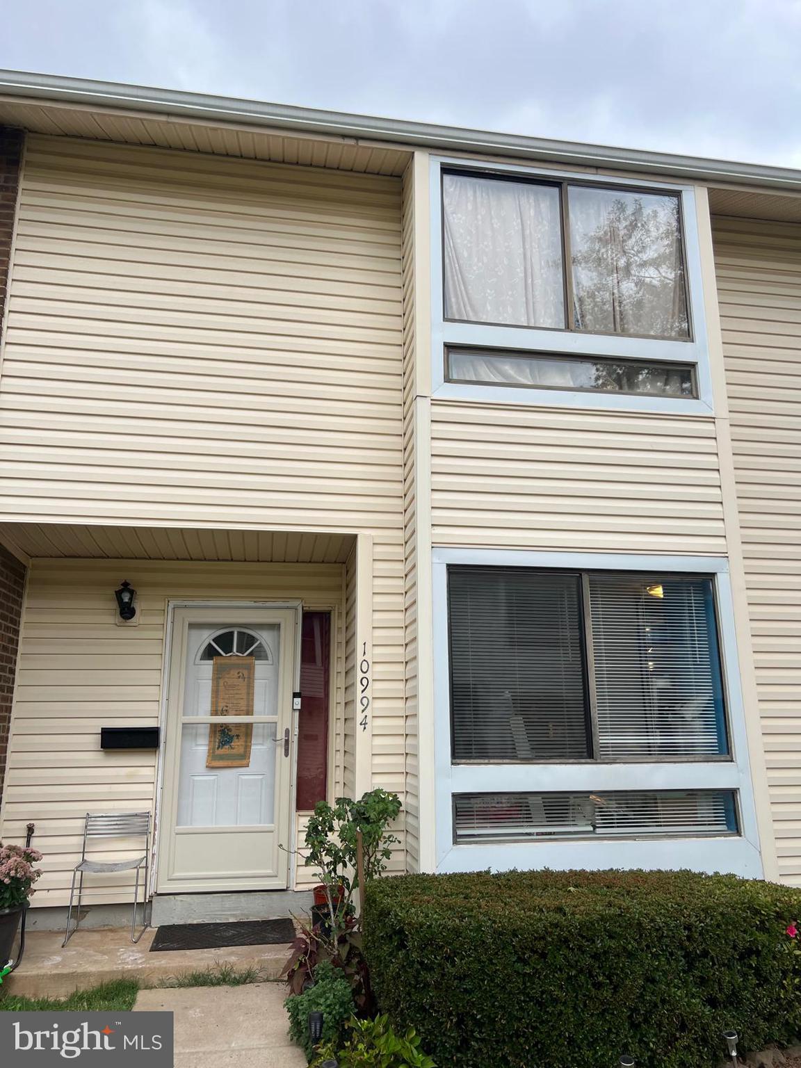 a view of a house with white door and a window