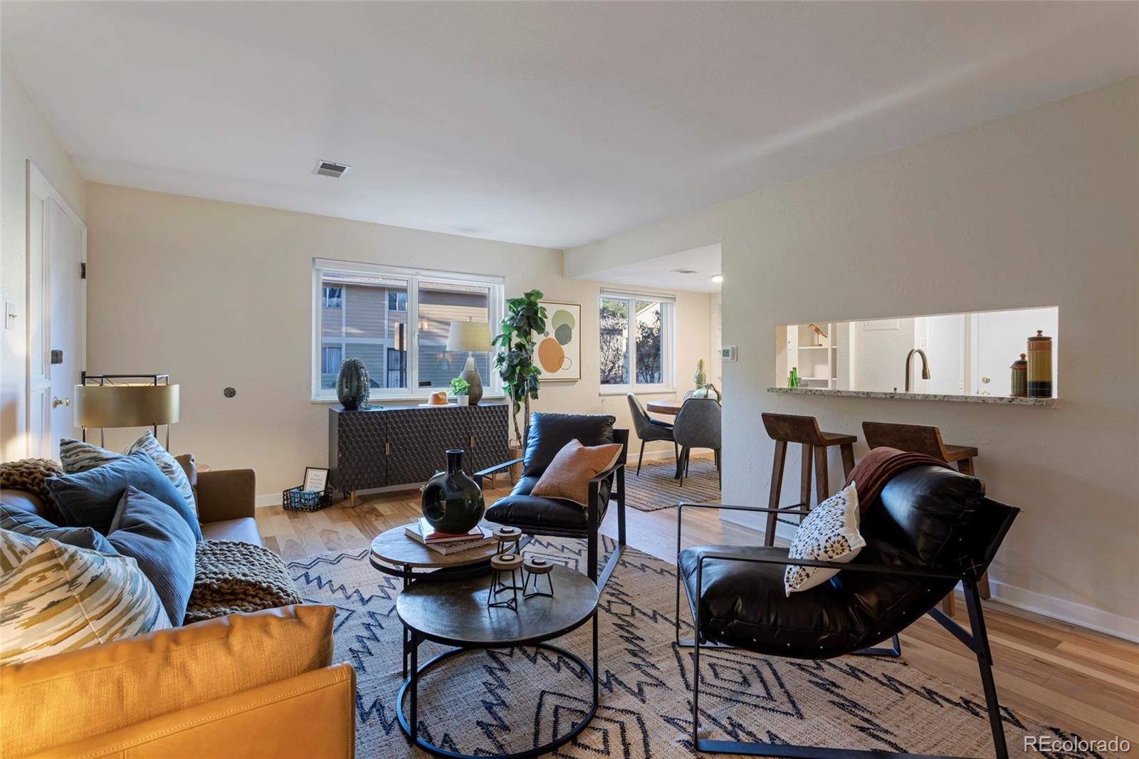 a living room with furniture and a dining table