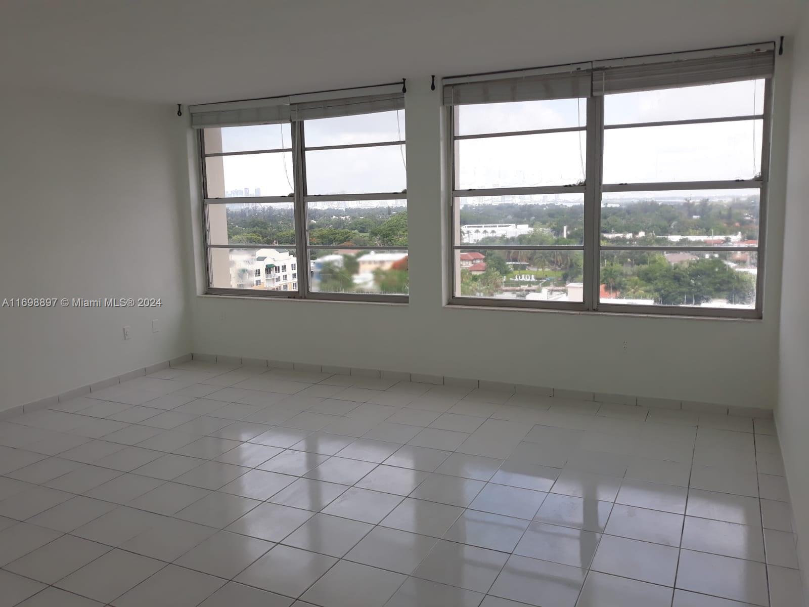 a view of an empty room with a window