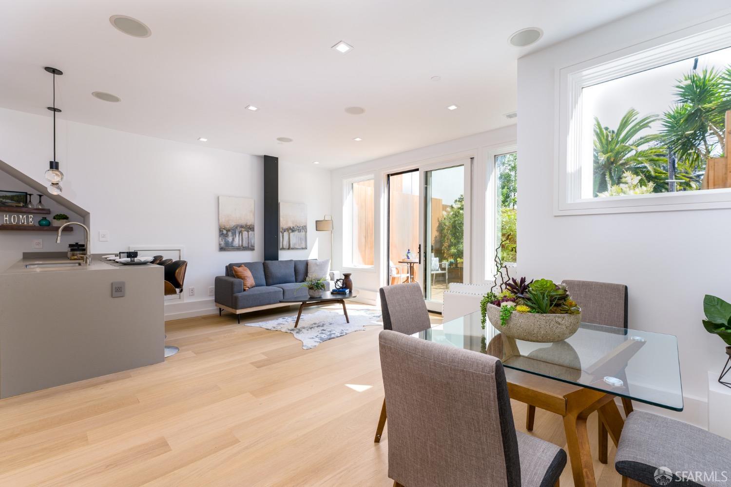 a living room with furniture and large windows