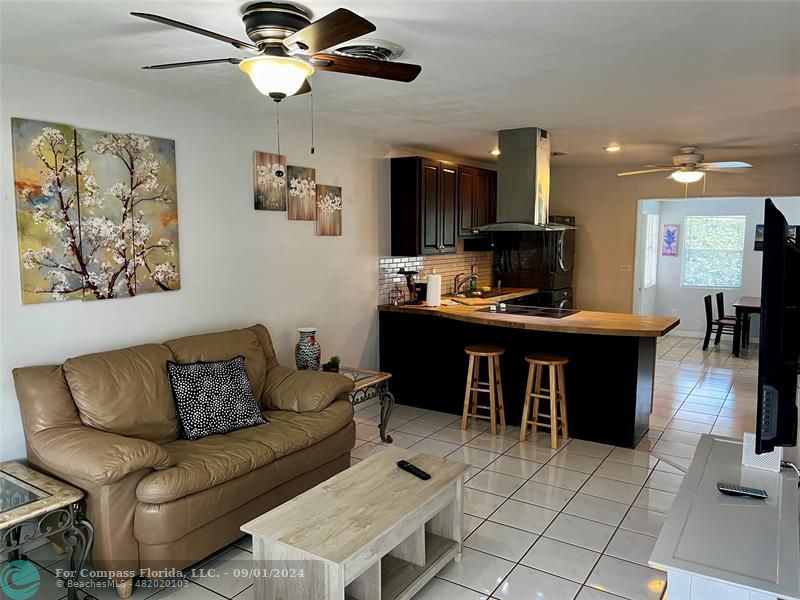 a living room with furniture a dining table and chairs