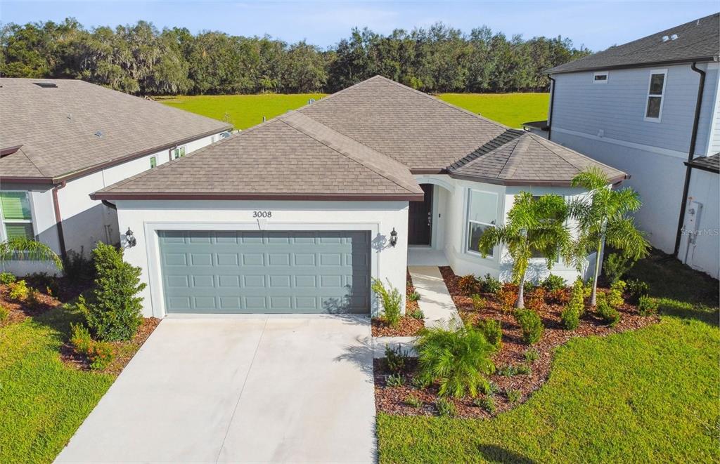 a aerial view of a house with pool and a yard