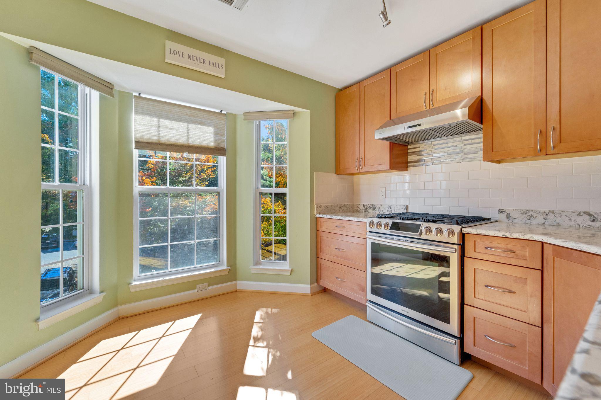 a kitchen with granite countertop a stove a sink and a cabinets