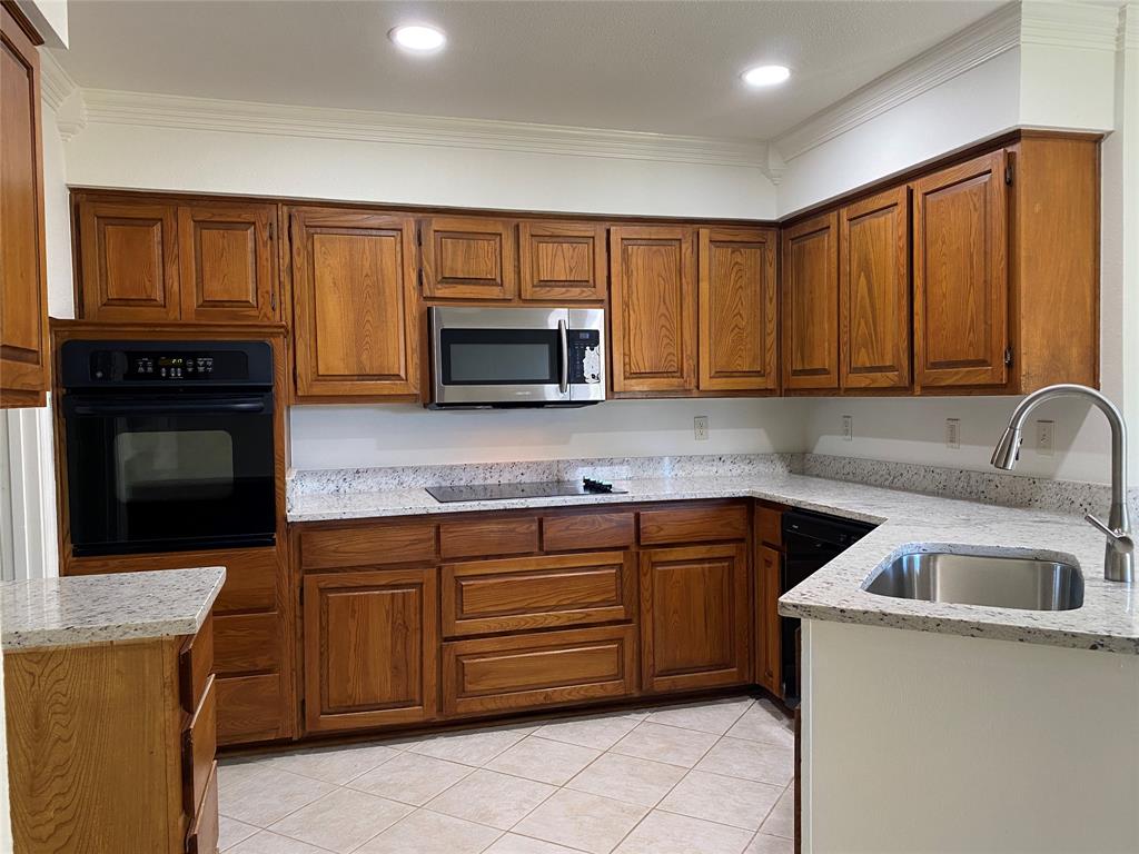 a kitchen with a sink stove and microwave