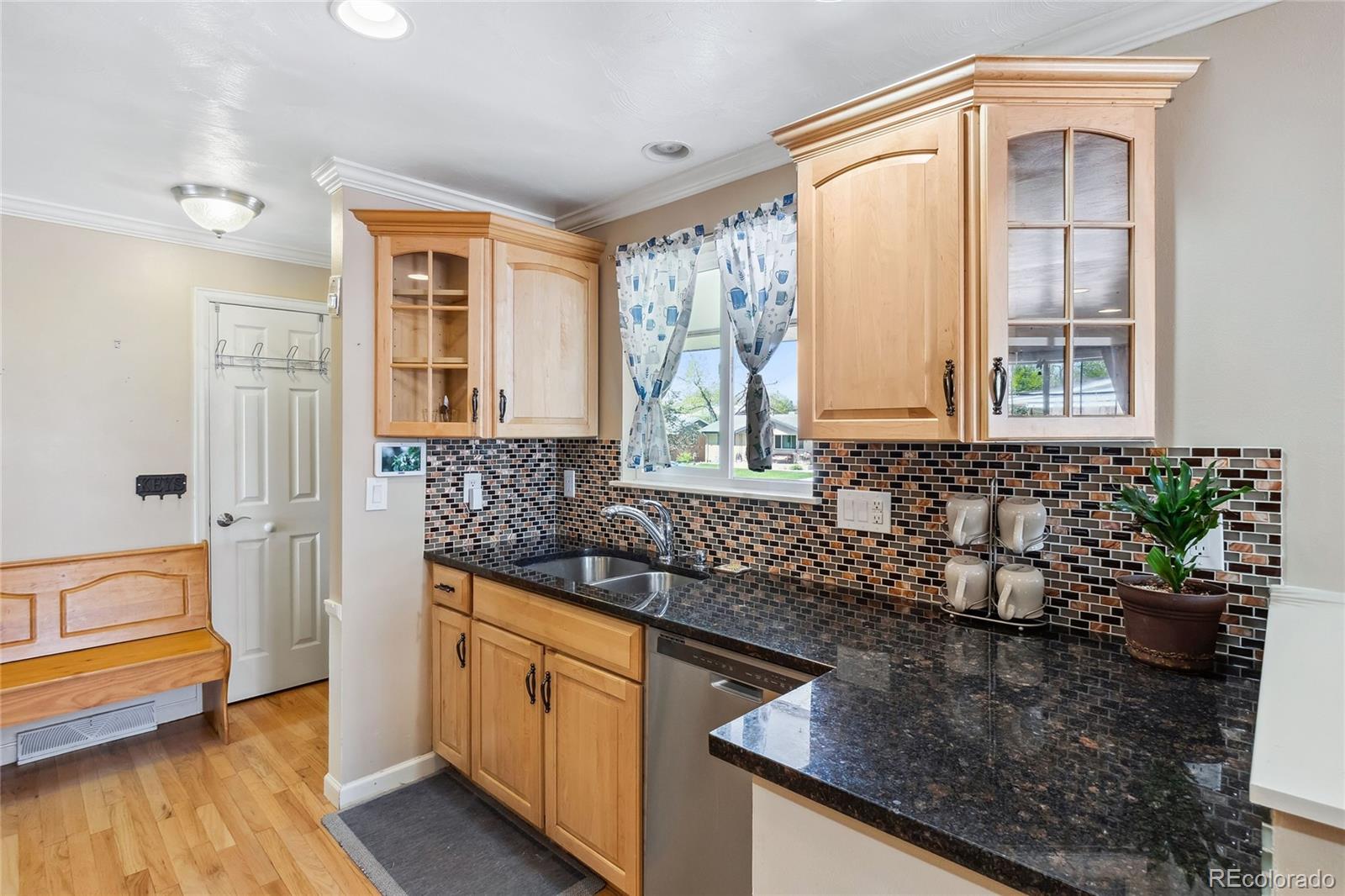 a kitchen with stainless steel appliances granite countertop a sink and a granite counter tops with a large window