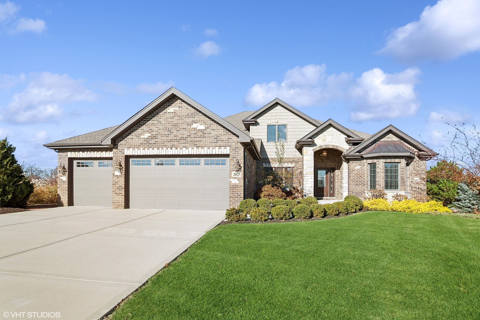 a front view of a house with a yard and garage