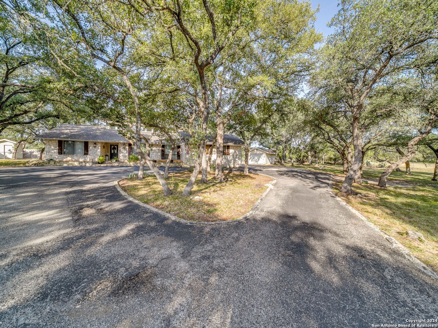 a view of yard with swimming pool and trees in the background