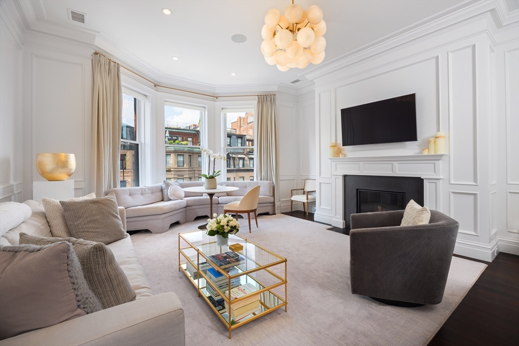 a living room with furniture fireplace and a flat screen tv