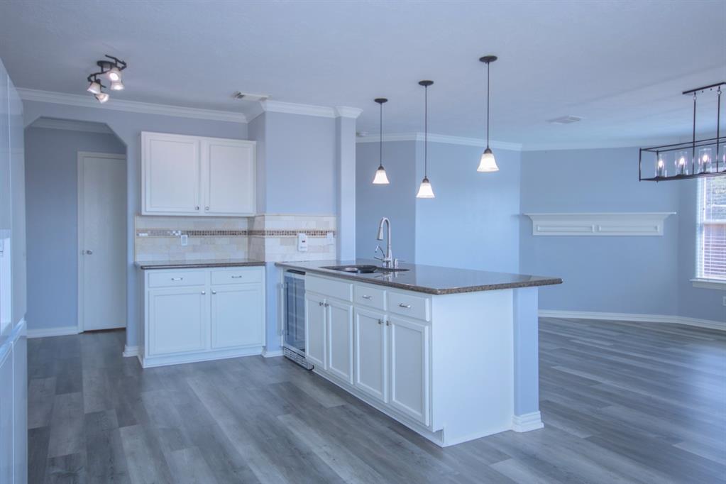 a kitchen with a sink a counter space and cabinets