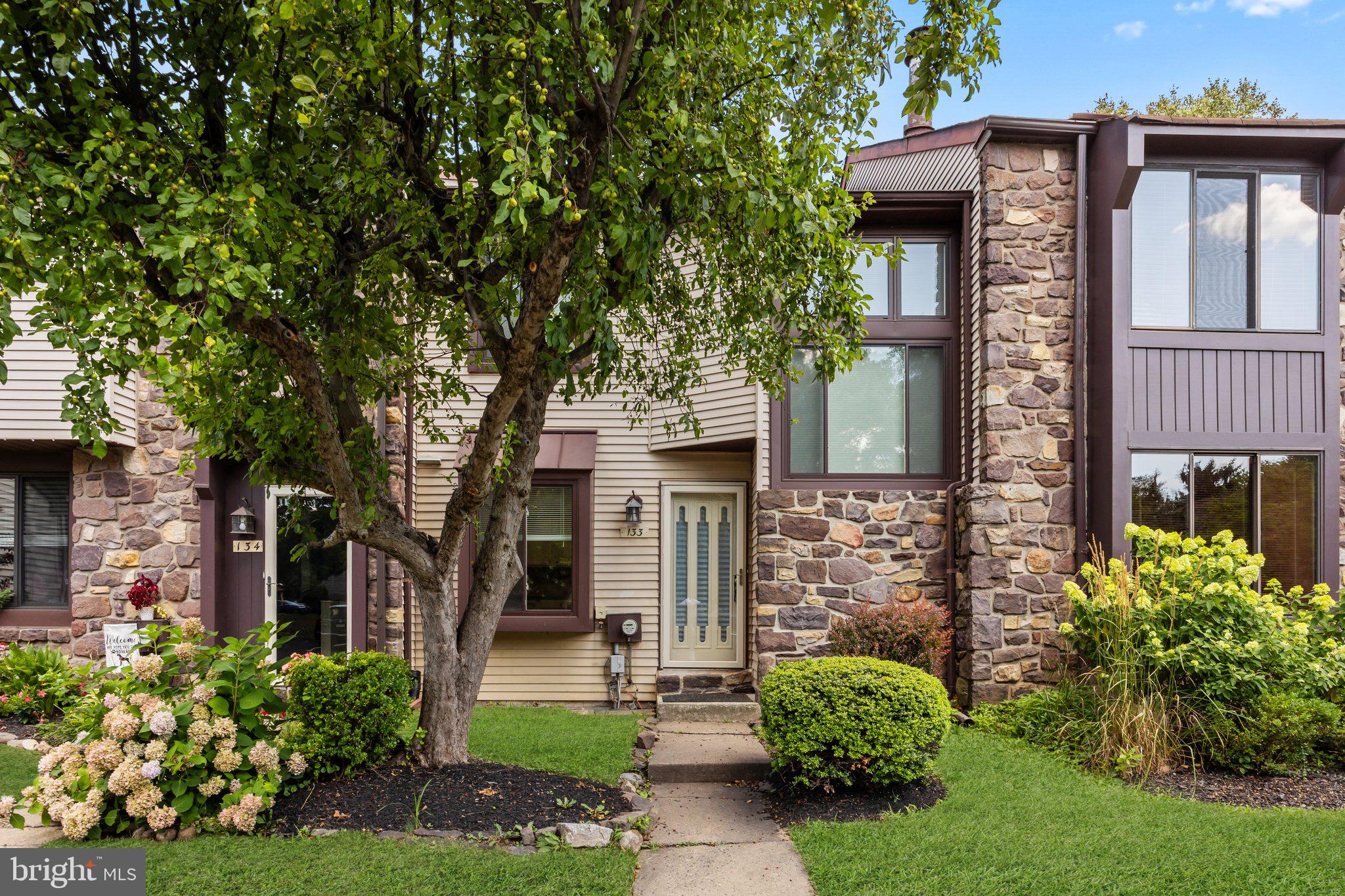 front view of a house with a tree