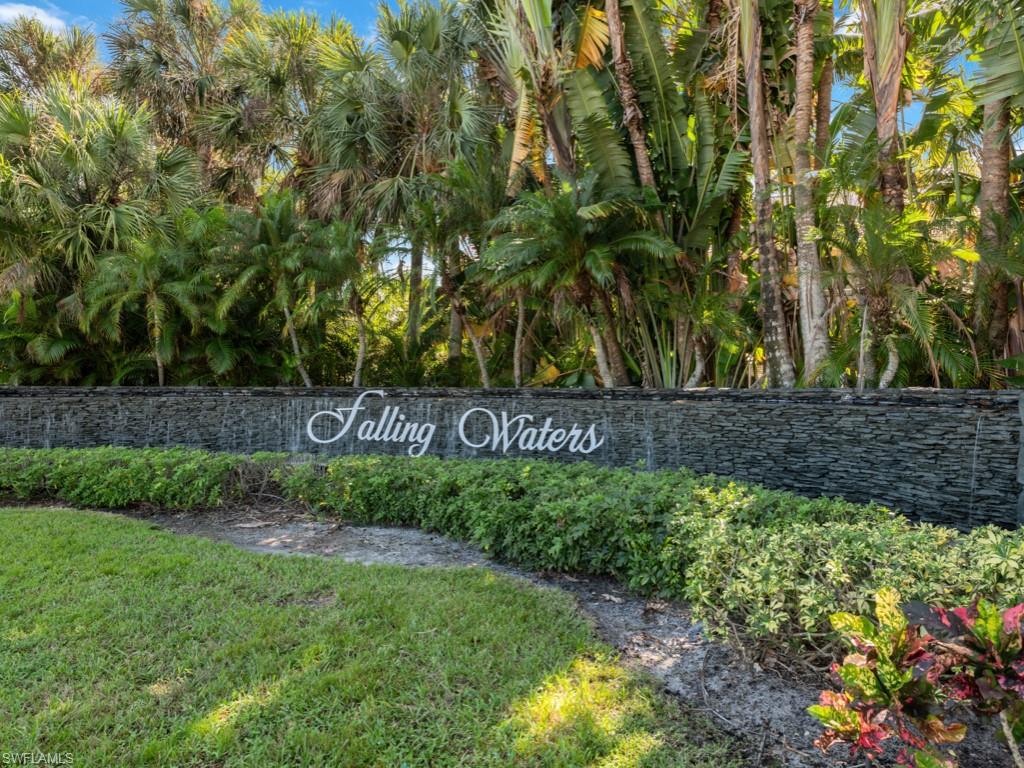 Community / neighborhood sign featuring a lawn