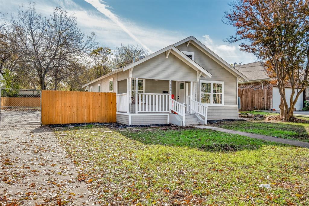 a view of a house with a yard and fence