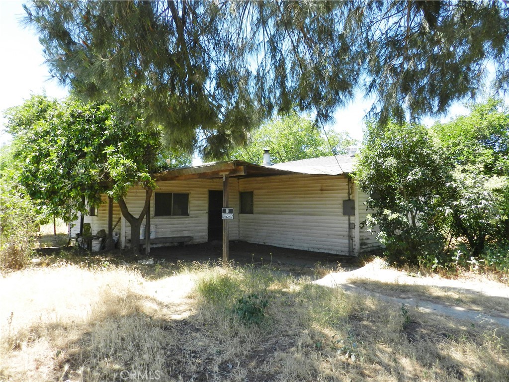 a view of a house with a large tree