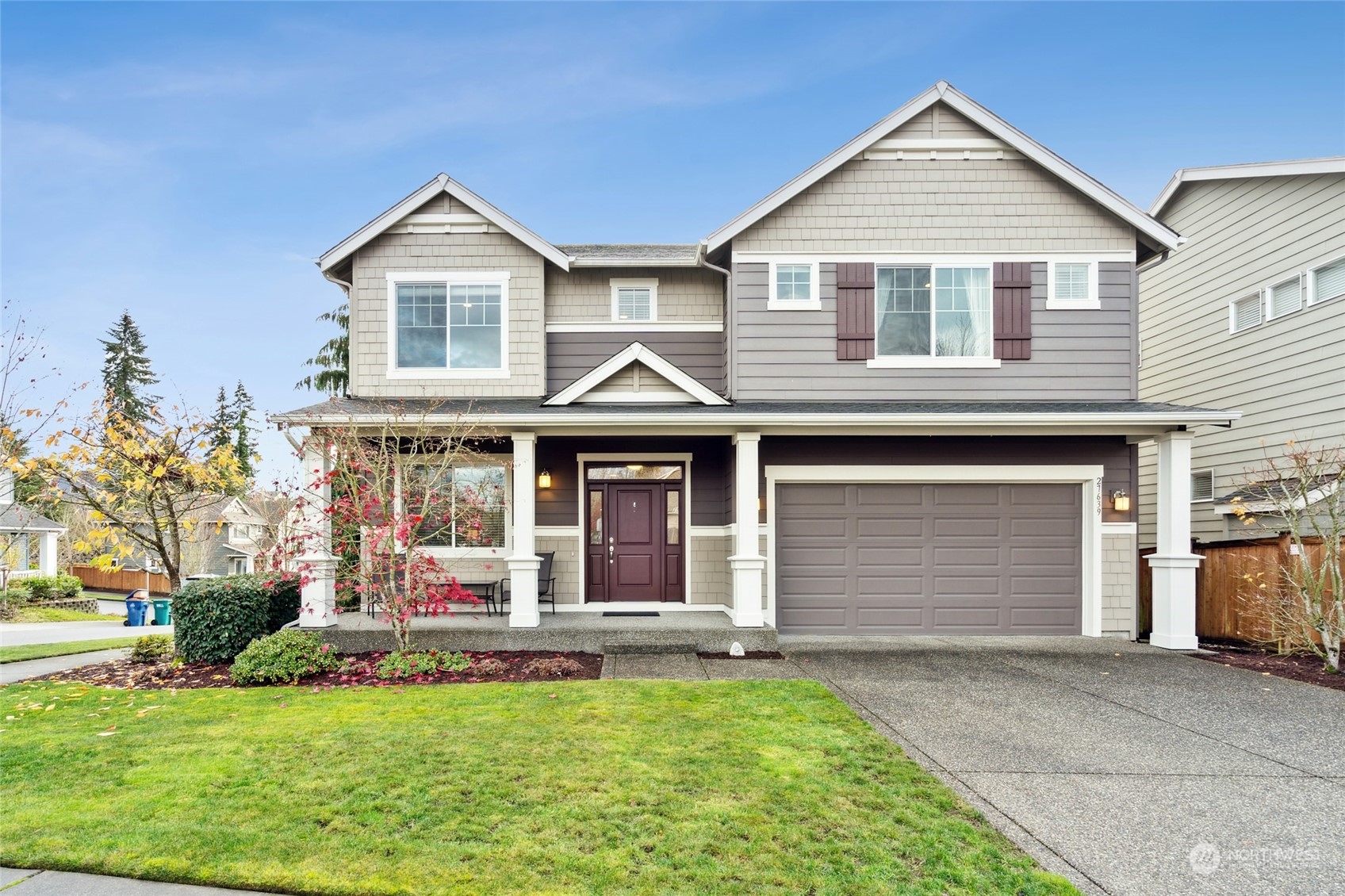 a front view of a house with a yard and garage