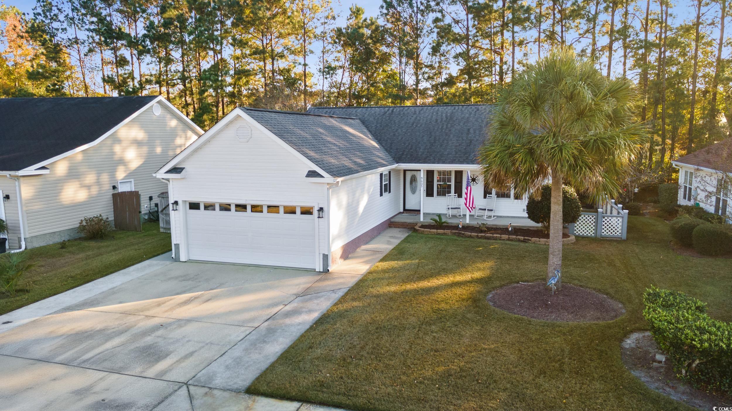 Single story home featuring a garage and a front l